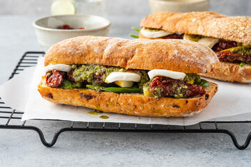 Fresh whole grain bun with tomato, pesto and mozarella. Copy space.