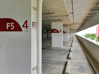 empty car parking lot building with concrete rod stoper and white line parking sign and fire protection system
