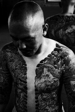 Black and White portrait of a Japanese man with traditional tattoos