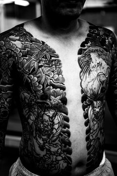 Traditionally tattooed Japanese man presenting his bare chest