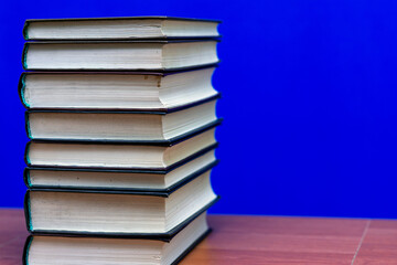 stack of old books, grungy background, free copy space blue background