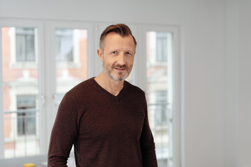 Handsome middle-aged man in brown sweater