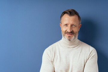 Attractive smiling man in a polo neck sweater