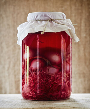 Still life of fermented pickled eggs with beets and herbs