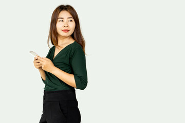 Fototapeta premium beautiful Asian business woman hand holding mobile phone standing over gray background 