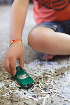 close up of boy playing with toy car