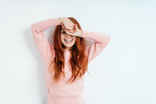 Vivacious Laughing Young Redhead Woman On White