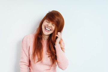 Cute vivacious playful young redhead woman - obrazy, fototapety, plakaty