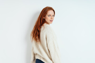 Young redhead woman looking quizzically back