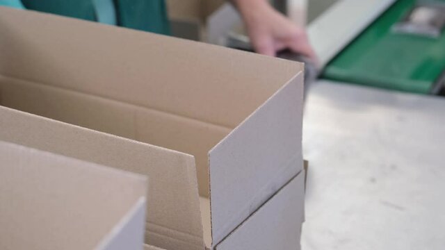 Factory made packaged chocolate bar. Dairy factory, production of chocolate bars in wrappers.Modern technologies. Packing into box.