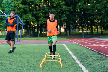 Children's football players during team training before an important match. Exercises for the youth football team.