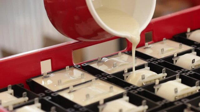 Pouring synthetic resin to insulate high voltage transformer electronic component in small factory or workshop - production of electronics and technology concept, close up