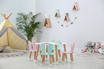 Cute children's room interior with teepee tent and little table