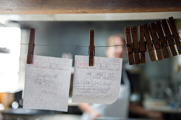 Order tickets in a restaurant held onto a string with clothespins