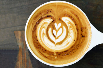 a cup of latte art coffee on wooden background                           