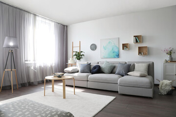 Fototapeta na wymiar Elegant living room with comfortable sofa near window. Interior design