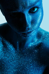 magic space woman in blue body art with glitters