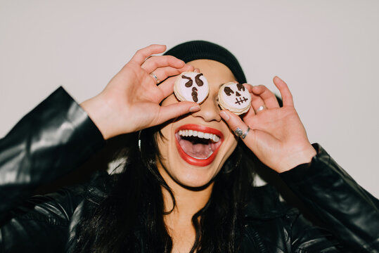 A woman eating halloween macarons