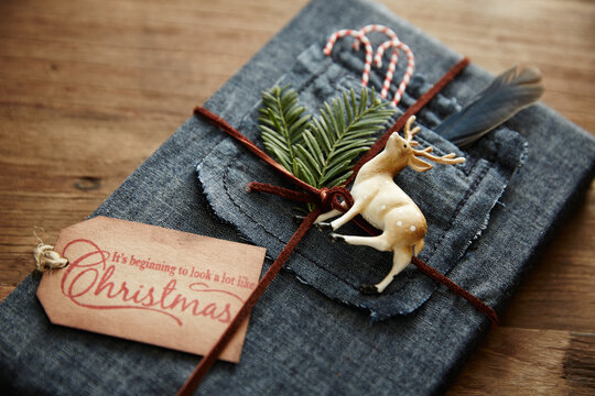 Hipster gift wrapped in denim with leather twine and ornaments