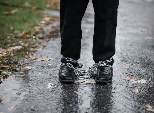 Ankles are bound with locks and chains