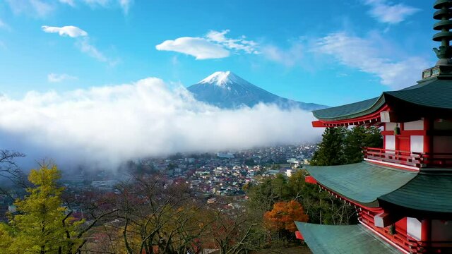 Aerial view 4k footage of Mount Fuji and mist view from behind Chureito Pagoda on morning, Yamanashi, Japan.