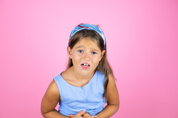 Young beautiful child girl over isolated pink background having a nausea