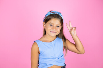 Young beautiful child girl over isolated pink background showing and pointing up with fingers number two while smiling confident and happy