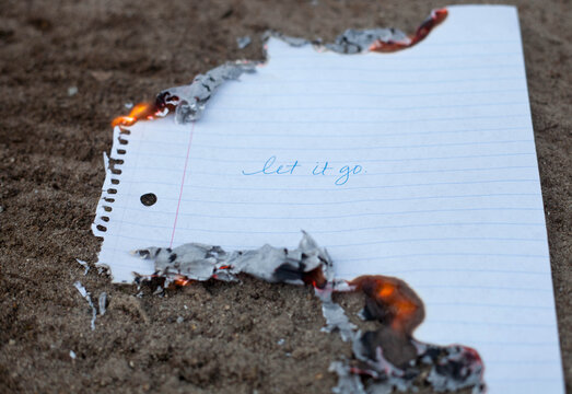 Burning a handwritten message saying Let it Go