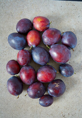 fresh plums on granite surface