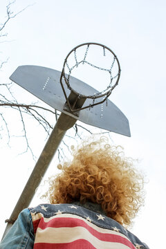 Ginger person under a basketball ring
