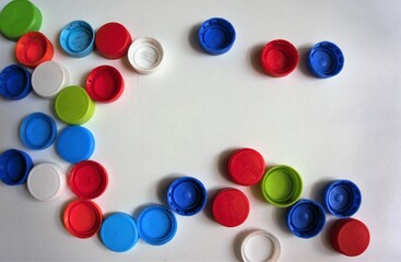 Image of the multi-colored soft drink bottle cap depicts a garbage reuse.