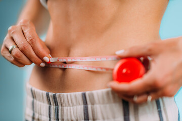 Women Measuring Her Waist with Tape Measure.