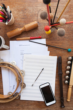 Overhead view of a music teacher's desk with random instruments