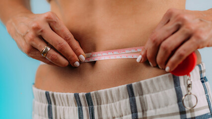 Waist Circumference. Women Measuring Her Waist.