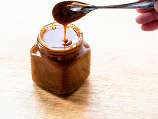 cooking salted butter caramel sauce at home kitchen - homemade smooth cooked salty caramel dessert...