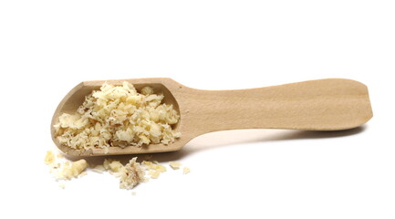 Milled walnuts pile in wooden spoon isolated on white background