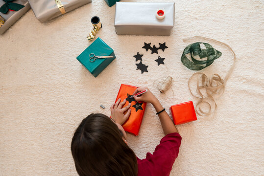 Girl making christmas presents.