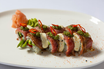 Beefsteak truffle sushi roll served on a white plate