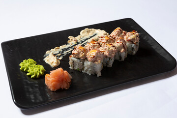 Steak tartare sushi roll served on a black stone, top view