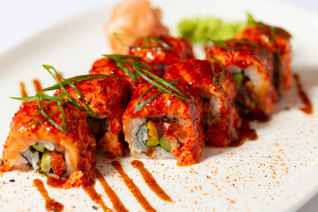 Chilly tobacco sushi roll served on a white plate