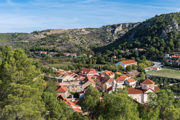 Fototapeta na wymiar View of the town of Skradin, Croatia surrounded by forest and mountains