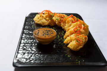 Japanese style deep fried shrimp served on a black stone