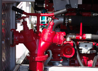 internal structure and equipment of a fire engine, close-up. Taps, valves, pipes are red. Mechanics
