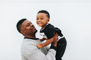 A father holding & showing his son love