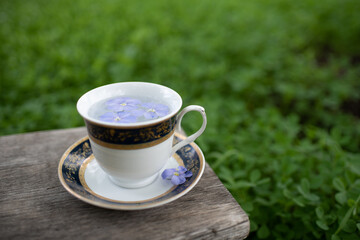 Vintage cup with saucer on a wooden bench, great design for any purposes.  Vintage style.