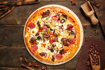Assorted beef pizza with salami and vegetables