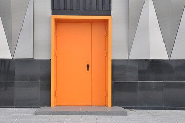 closed metal fire door in orange color.