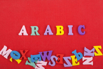ARABIC word on red background composed from colorful abc alphabet block wooden letters, copy space for ad text. Learning english concept.