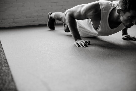 Young, healthy man working out in gym - pushups
