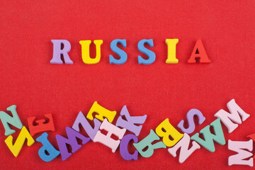 Russia word on red background composed from colorful abc alphabet block wooden letters, copy space for ad text. Learning english concept.